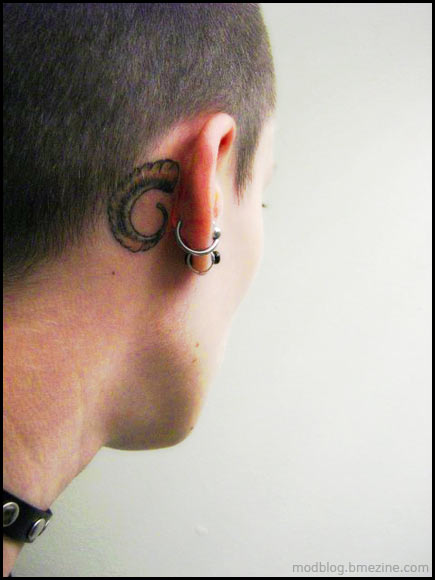 I quite like this little ram horn tattoo behind the ears 